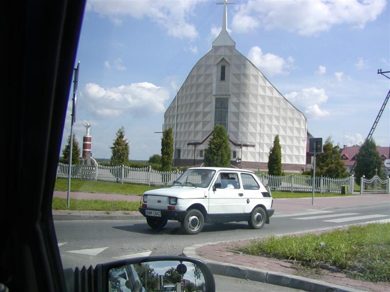 A Polski Fiat in front of one of many modern churches in Poland.
